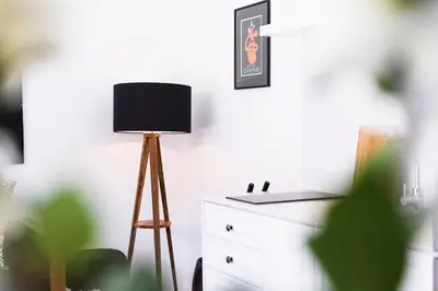 a room with a table with a lamp and a dresser at Villa Bella Seminyak in Seminyak