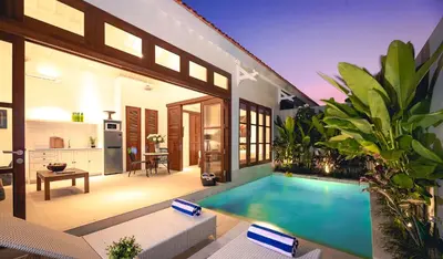 a house with a swimming pool in a yard at Villa Bella Seminyak in Seminyak