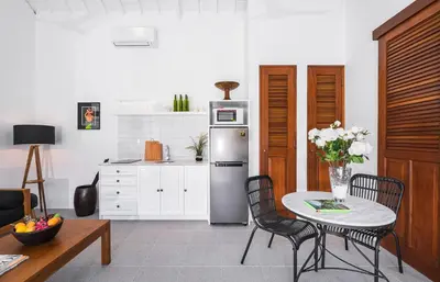 a kitchen with a table and a refrigerator at Villa Bella Seminyak in Seminyak