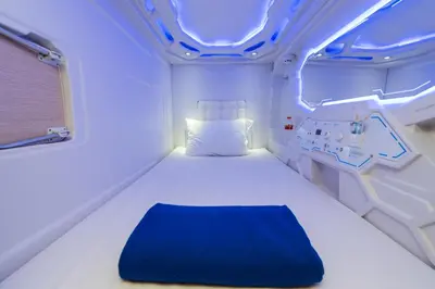 a room with a bed in a hospital room at PassGo Digital Airport Hotel Bali in Kuta
