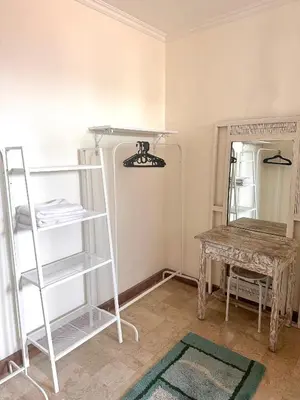 a room with shelves and a table and a table at Turtledove Guesthouse in Kerobokan