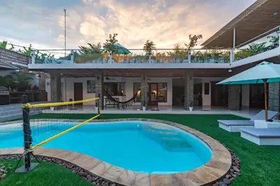 a villa with a swimming pool and a house at 5 BR Villa Sultan Luxury Entertainment and Relaxation in Seminyak