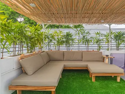 a couch sitting under a wooden roof at 5 BR Villa Sultan Luxury Entertainment and Relaxation in Seminyak