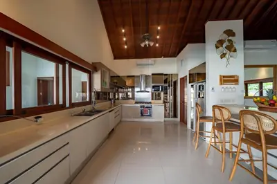 a kitchen with white counters and wooden ceilings at 5 BR Villa Sultan Luxury Entertainment and Relaxation in Seminyak