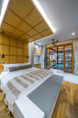 a large bedroom with a large bed and wooden floors at Villa Mango 3 - Amazing 4-bdr Villa in Berawa ! PERFECT LOCATION ! in Canggu