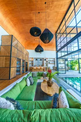 a large living room with a green couch and a table at Villa Mango 3 - Amazing 4-bdr Villa in Berawa ! PERFECT LOCATION ! in Canggu