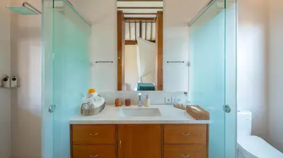 a bathroom with a sink and a mirror at Villa Aloui by Villa Finder in Kerobokan