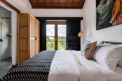 a bedroom with a large white bed with a window at 2 Zen Bali Villa Canggu in Canggu