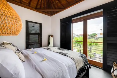 a bedroom with a bed and a large window at 2 Zen Bali Villa Canggu in Canggu