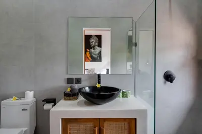 a bathroom with a black bowl sink on a counter at 2 Zen Bali Villa Canggu in Canggu