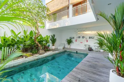 a swimming pool in a house with plants at Selog Seven in Seminyak