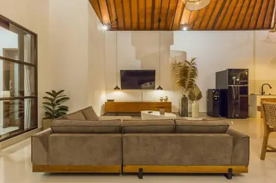 a living room with a couch and a tv at Charming 3 Bedrooms Villa Beach Walking Distance in Seminyak