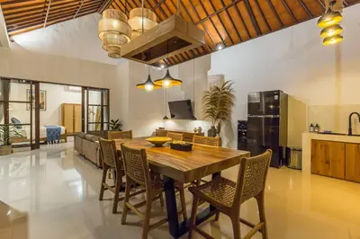 a kitchen and dining room with a wooden table and chairs at Charming 3 Bedrooms Villa Beach Walking Distance in Seminyak