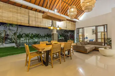 a dining room with a wooden table and chairs at Charming 3 Bedrooms Villa Beach Walking Distance in Seminyak