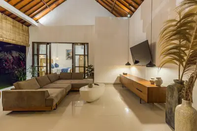 a living room with a couch and a table and a tv at Charming 3 Bedrooms Villa Beach Walking Distance in Seminyak