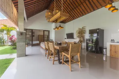 a dining room with a wooden table and chairs at Charming 3 Bedrooms Villa Beach Walking Distance in Seminyak