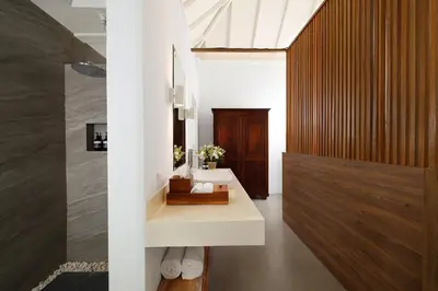 a bathroom with a white sink and a mirror at Villa Swarna by Nakula in Seminyak