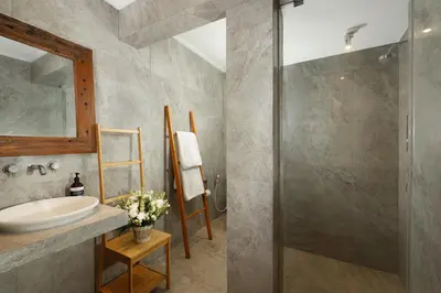 a bathroom with a sink and a shower at Villa Swarna by Nakula in Seminyak