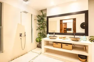 a bathroom with two sinks and a mirror at Villa Nikko I - 4Br Villa in Central Seminyak, Steps to Cafés & Shops in Seminyak