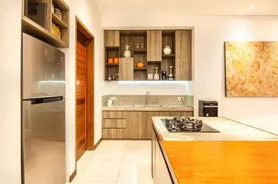 a kitchen with a counter and a stove top oven at Villa Nikko I - 4Br Villa in Central Seminyak, Steps to Cafés & Shops in Seminyak