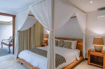 a bedroom with a bed with a canopy at Villa Amore - Elegant 4-br Villa close to the beach in Canggu