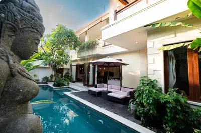 a villa with a swimming pool and a building at Villa Tepi Sungai - 6BR Luxury Private Pool Villa - Seminyak Sleeps 14 in Legian