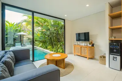 a living room with a couch and a tv and a table at 4 Bdr -Villa Donna, Fast Wi-Fi & Private Pool in Canggu