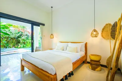 a bedroom with a bed and a large window at 4 Bdr -Villa Donna, Fast Wi-Fi & Private Pool in Canggu
