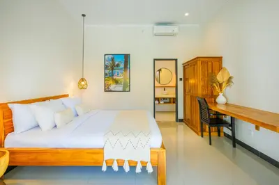 a bedroom with a large bed and a desk at 4 Bdr -Villa Donna, Fast Wi-Fi & Private Pool in Canggu
