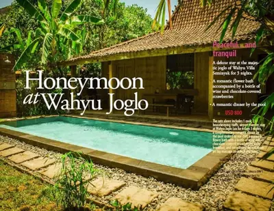 a magazine cover of a swimming pool in front of a house at Wahyu wonderful private honeymoon joglo in Seminyak