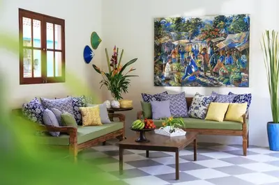 a living room with a couch and a painting on the wall at Villa Kayan - Gorgeous 2BR Seminyak gem, fabulous location steps from restaurants, cafes and shopping in Seminyak