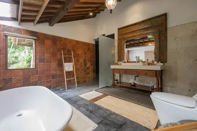 a bathroom with a sink and a mirror at The Lavana Ziza Living And Villas Seminyak in Kerobokan