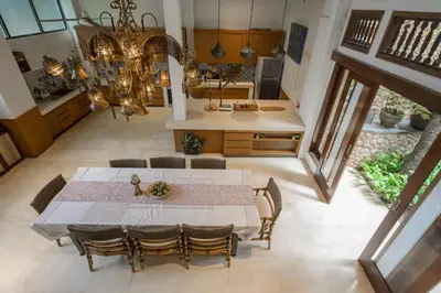 a kitchen and dining room with a table and chairs at The Lavana Ziza Living And Villas Seminyak in Kerobokan