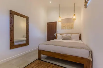 a bedroom with a bed and a mirror at Central 4 bedr villa 5min walk from eat street&Beach in Seminyak