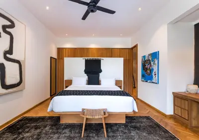 a bedroom with a bed and a ceiling fan at Villa Wolfe by Villa Finder in Seminyak