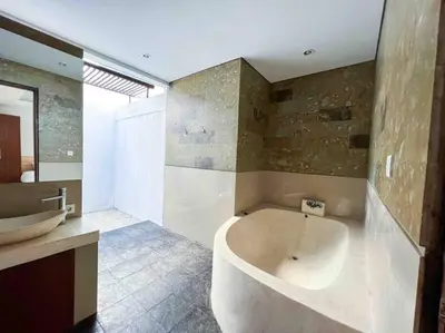a bathroom with a large tub and a sink at Cosy and Cheerful 2 Bedroom villa 5mins to Finns in Canggu