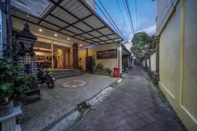 an alley with a building and a motorcycle parked next to it at Padma Lodge Legian in Seminyak