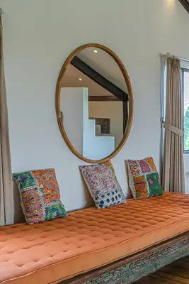 a mirror sitting on top of a bed with pillows at Villa Elma - Huge 2-bedroom pool villa in Umalas! in Seminyak