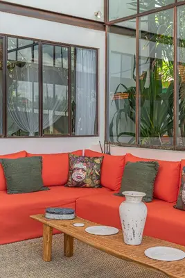 a red couch with a coffee table in a room at Villa Elma - Huge 2-bedroom pool villa in Umalas! in Seminyak
