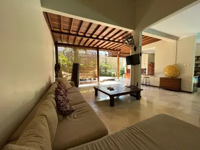 a living room with a couch and a table at KUTA - 4BR Villa with Private XL Pool in Kuta