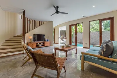 a living room with a couch and a table at Ajiorqo Villa in Seminyak