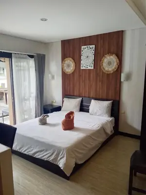 a bedroom with a bed with two stuffed animals on it at NEW KUBU DI BUKIT apartemen & motor bike rental near beach and 10 minute to airpot in Jimbaran