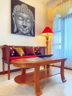 a living room with a couch and a table at Villa Cantik Kuta Regency in Kuta