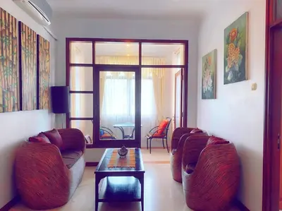 a living room with two chairs and a table at Villa Cantik Kuta Regency in Kuta
