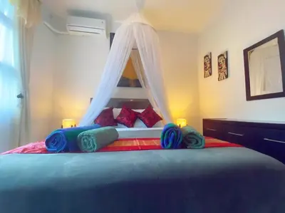 a bedroom with a bed with a canopy at Villa Cantik Kuta Regency in Kuta