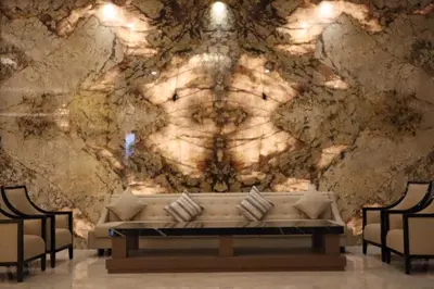 a living room with a couch in front of a wall at Dream of Aventus Hotel Kuta in Kuta