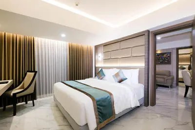 a hotel room with a bed and a desk and a room at Dream of Aventus Hotel Kuta in Kuta