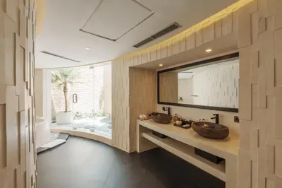 a bathroom with two sinks and a large mirror at Villa Rose in Seminyak