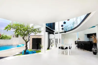 an open living room with a pool and a dining room at Villa Rose in Seminyak