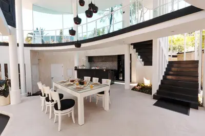 a dining room with a white table and chairs at Villa Rose in Seminyak